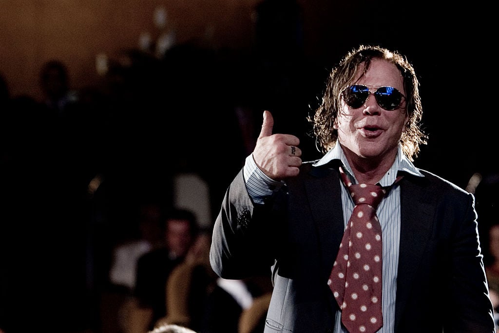 Mickey Rourke smiling wearing sunglasses with a thumbs up