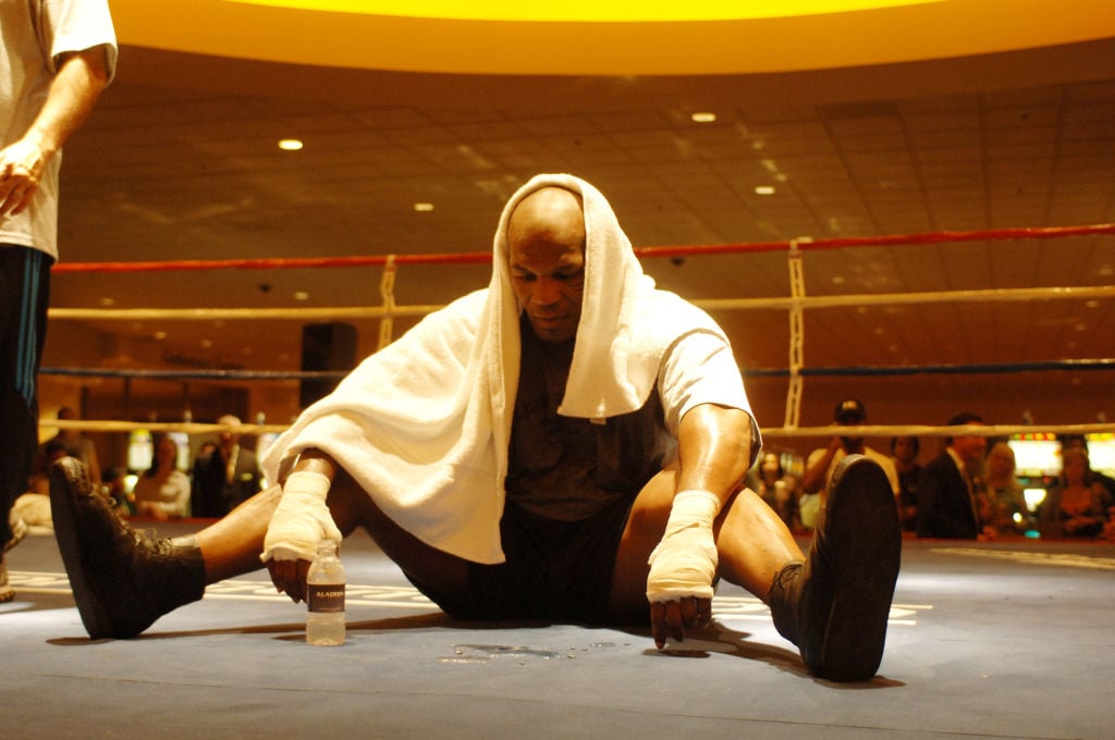 Mike Tyson sitting down during a training camp