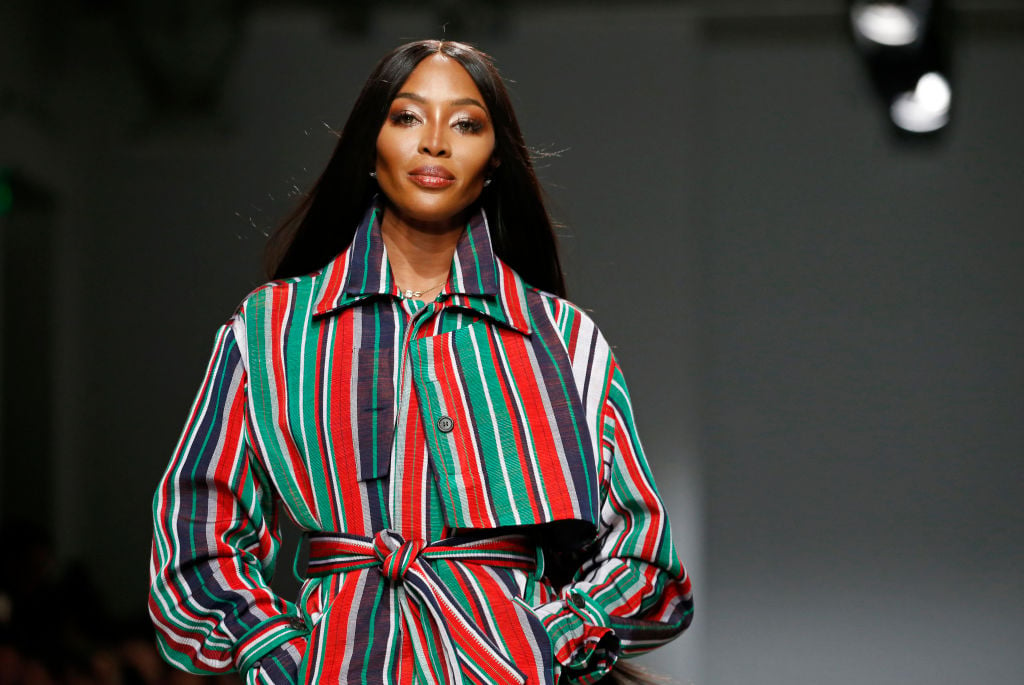 Naomi Campbell on a runway, smiling