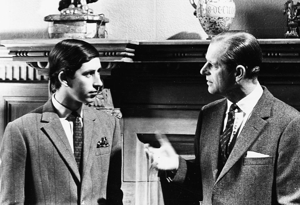 Prince Charles (left) talking to his father, the Duke of Edinburgh, in front of a fireplace at Sandringham, Scotland, 1969.