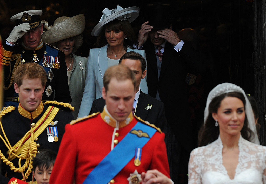 Prince William and Kate Middleton at their royal wedding followed by family