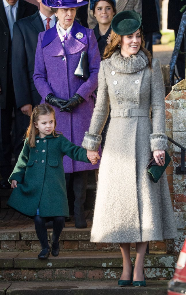 Princess Charlotte attempts a curtsey standing next to Kate Middleton during Christmas Day church service in 2019