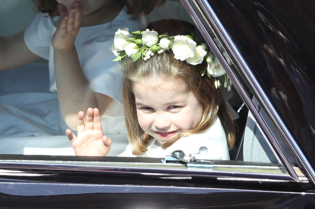 Princess Charlotte waves while attending the royal wedding of Princess Eugenie and Jack Brooksbank