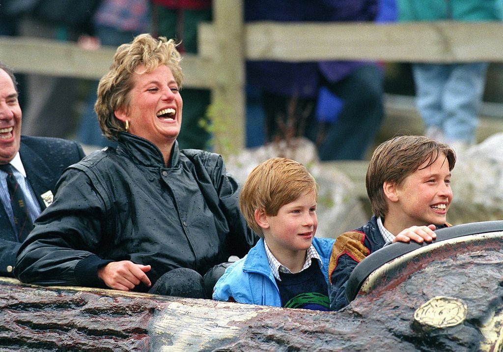 Princess Diana laughs during a ride at an amusement park with Prince William and Prince Harry