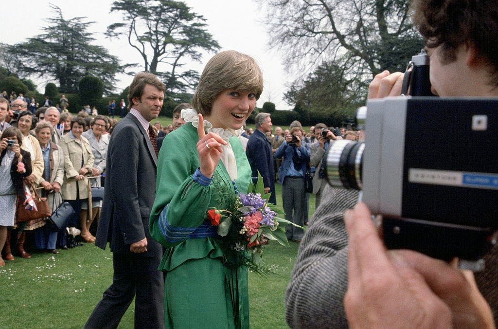 Princess Diana points a finger at photographers