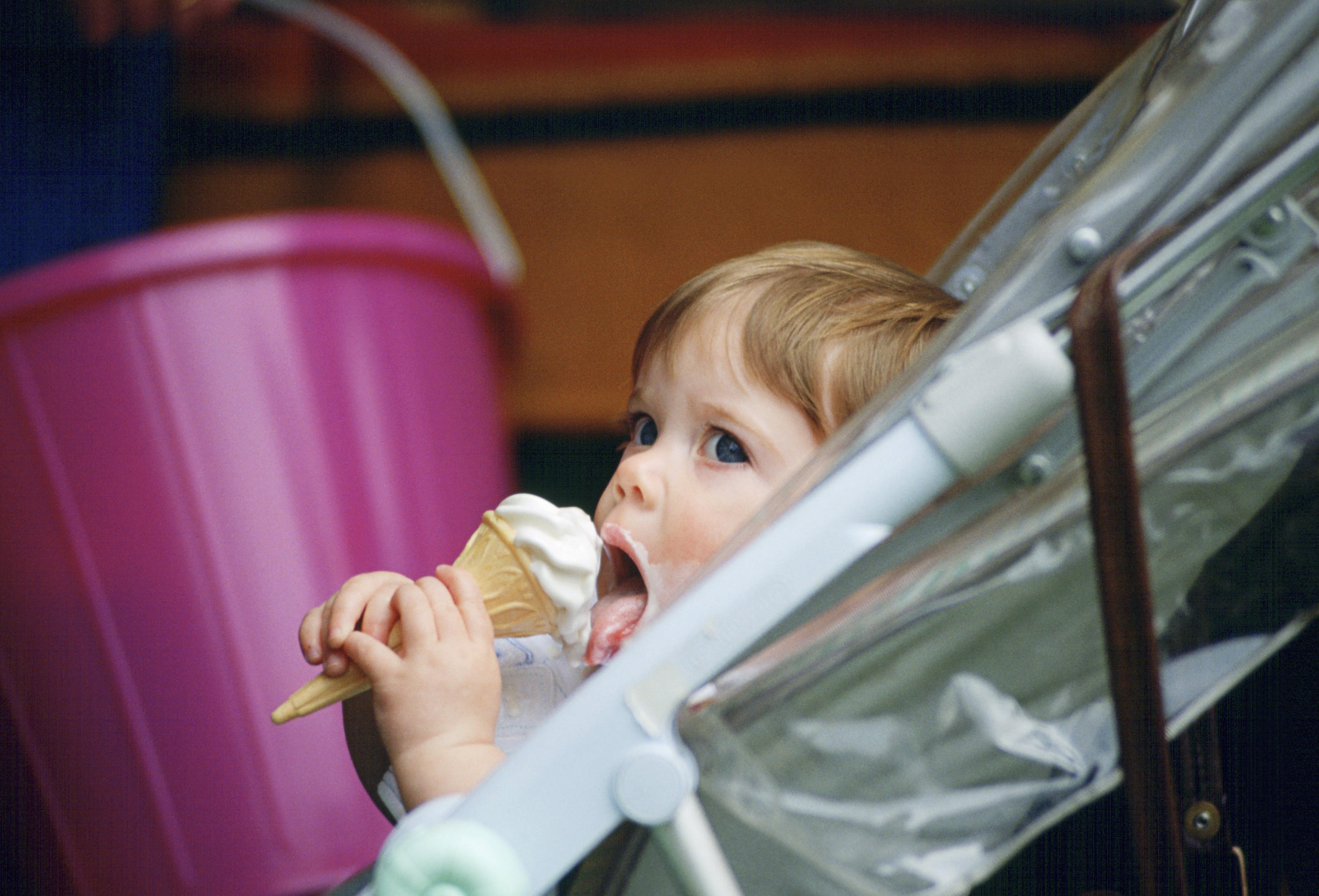 Princess Eugenie eats an ice cream cone in her stroller at the Windsor Horse Show