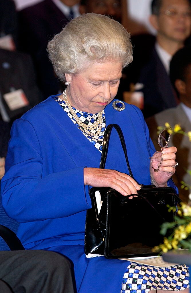 Why Queen Elizabeth II Always Carries This Bizarre Item in Her Handbag When  She Travels