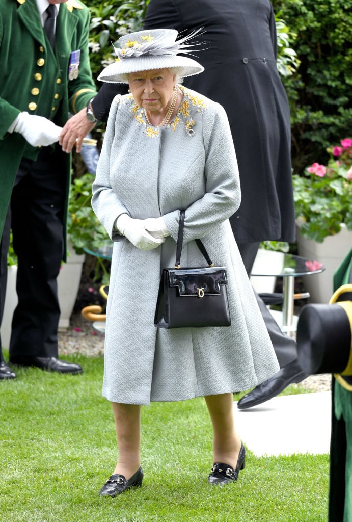 Why Does the Queen Always Carry a Purse?