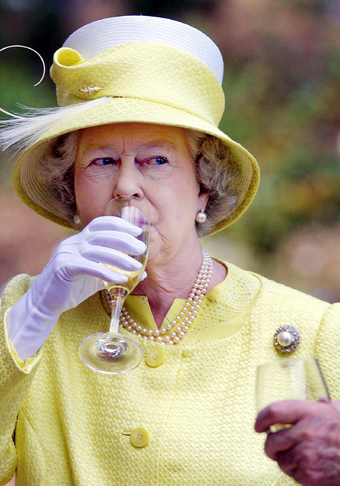 Queen Elizabeth II drinking wine in 2002