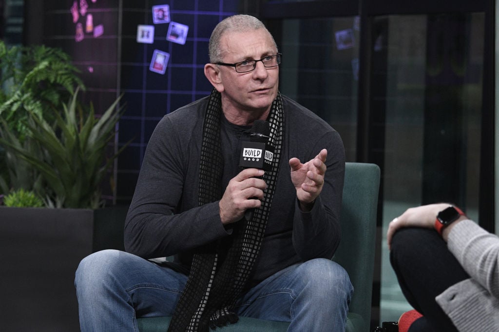 Robert Irvine holding a microphone, seated, talking