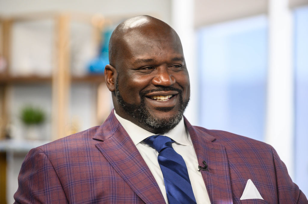 Shaquille O'Neal smiling, looking away from the camera