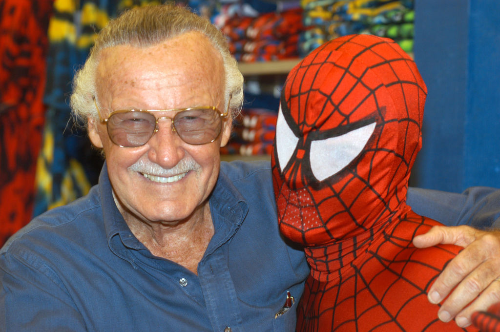 Stan Lee poses with Spider-Man