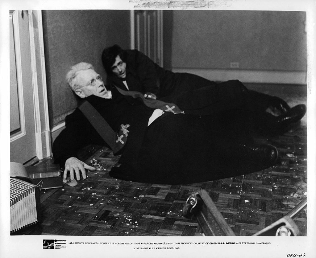 Max Von Sydow and Jason Miller lay on floor after being thrown from bed in a scene from the film 'The Exorcist'