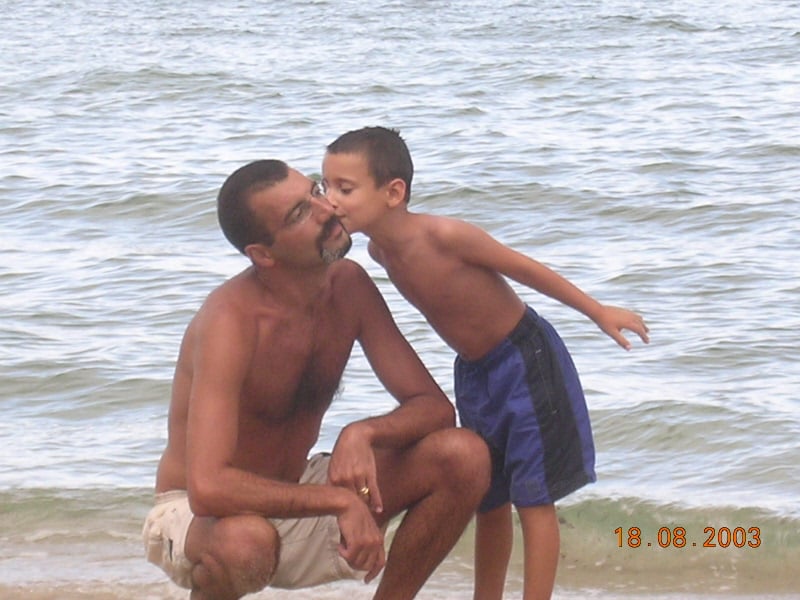 man and his son on a beach