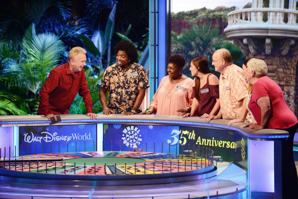 Pat Sajak and contestants on 'Wheel of Fortune'