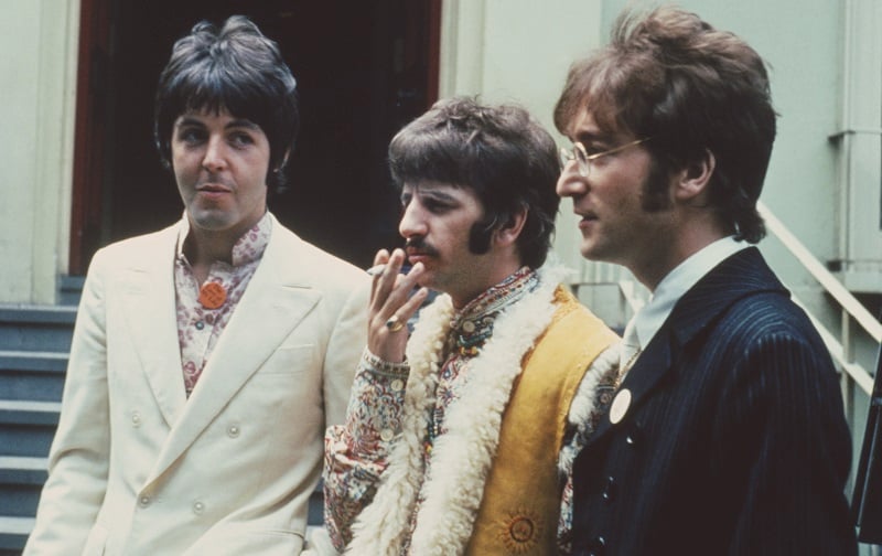 Beatles Paul, Ringo, and John stand outside Abbey Road studios