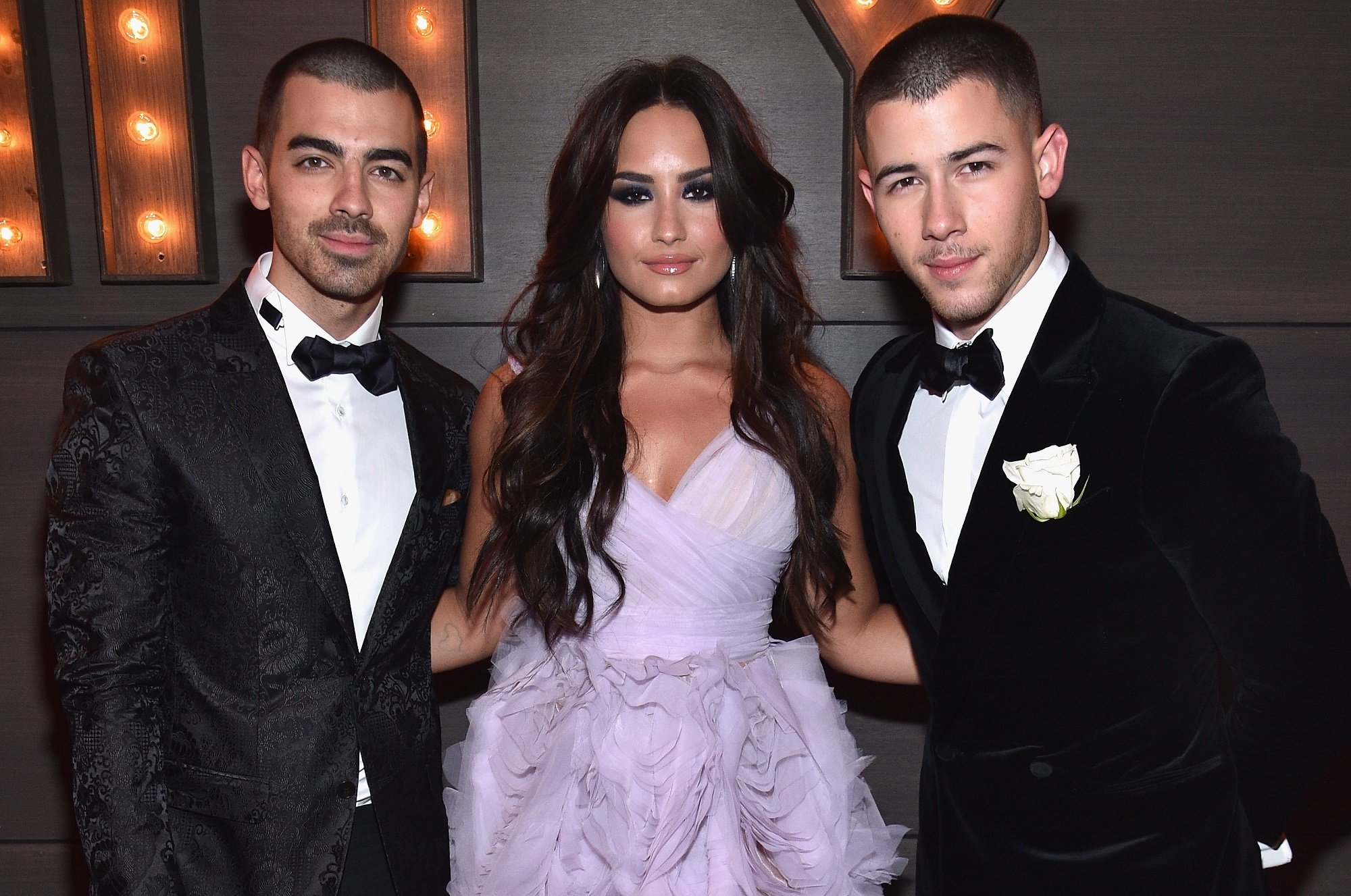 Joe Jonas, Demi Lovato, and Nick Jonas attend the 2017 Vanity Fair Oscar Party 