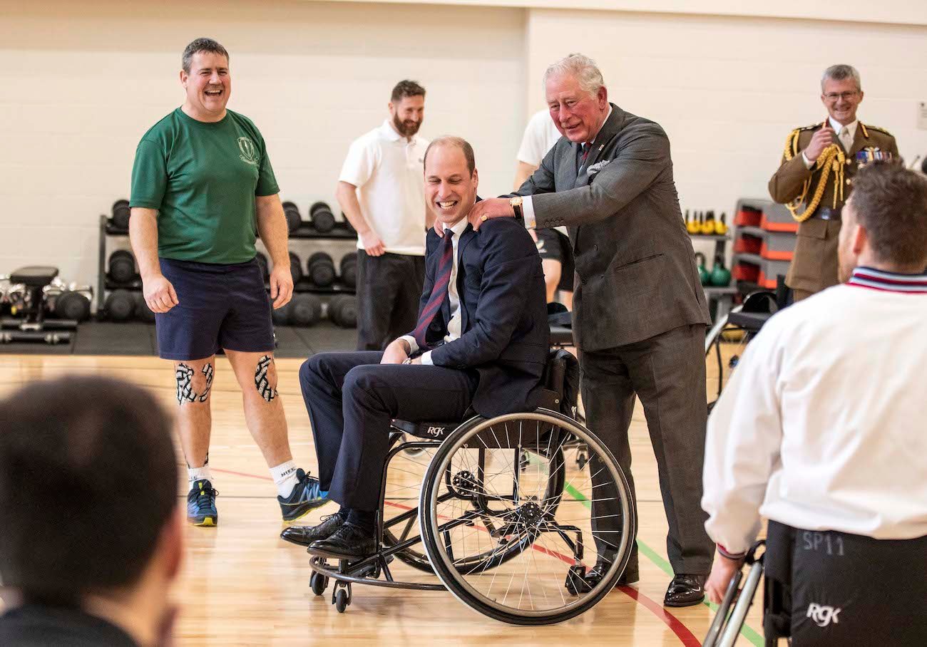 Prince William and Prince Charles after the duke attempted and failed to throw a basket ball into the hoop from a wheelchair during a visit to the defence medical rehabilitation centre (DMRC) in Nottinghamshire