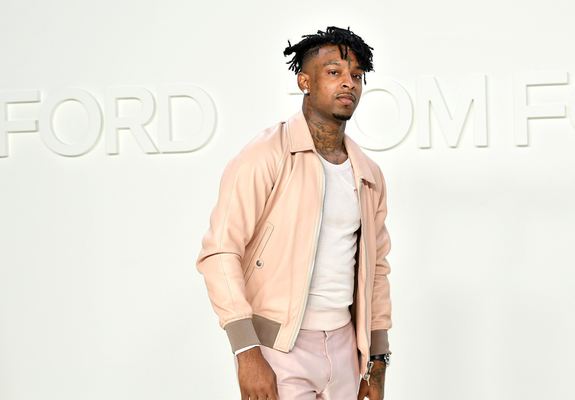 21 Savage turned slightly, looking at the camera, in front of a white background