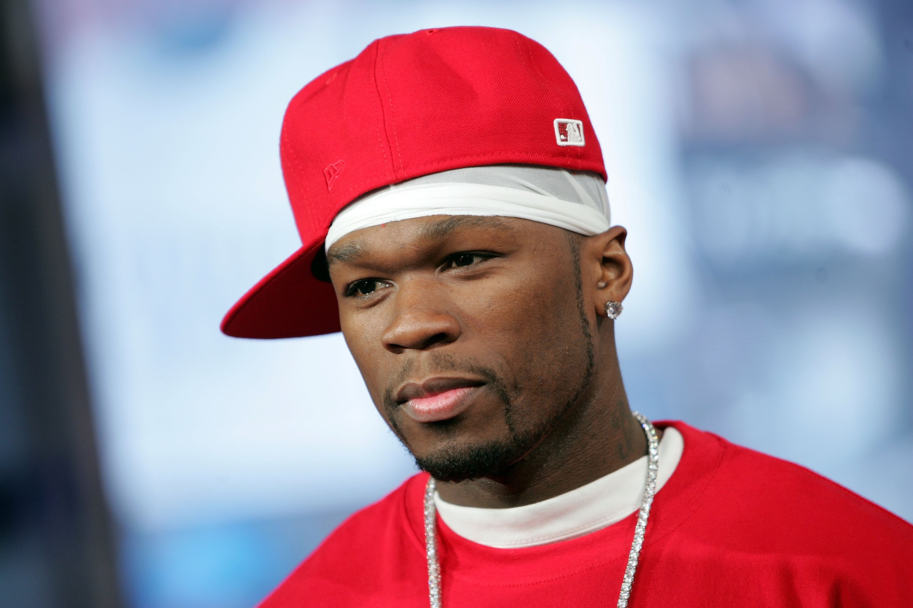 50 Cent wearing a red baseball cap