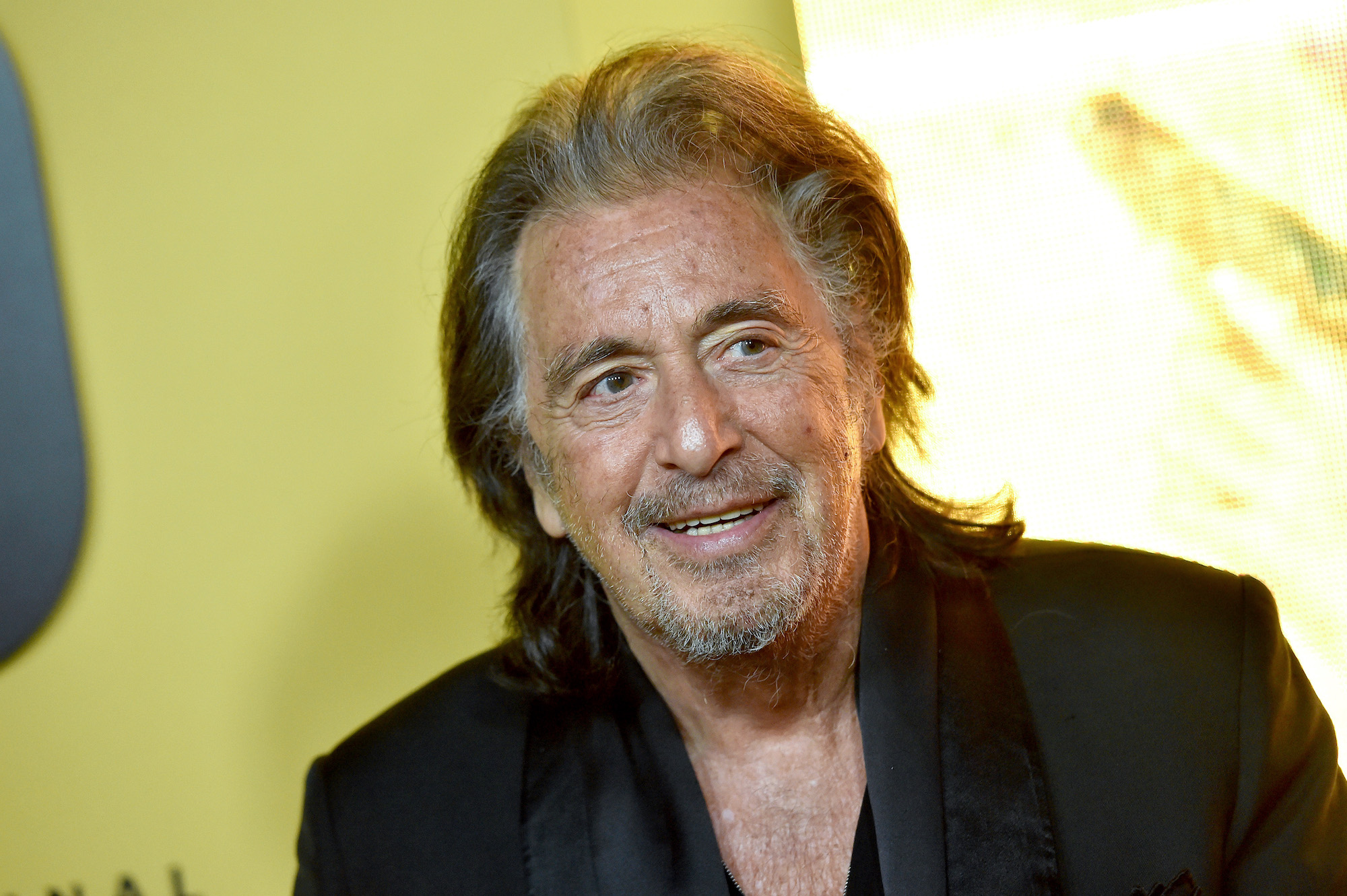 Al Pacino smiling, looking off camera