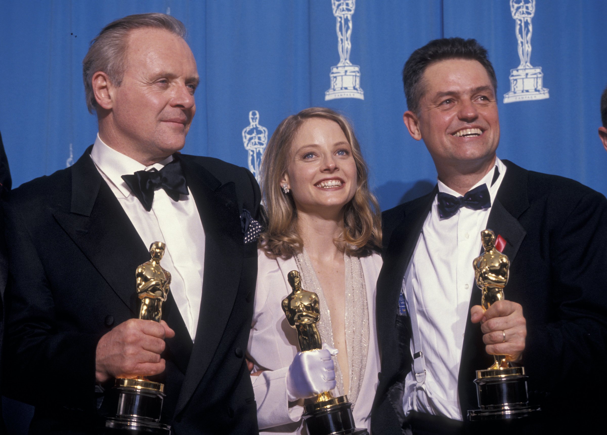 Anthony Hopkins, Jodie Foster, and Jonathan Demme pose with their Oscar statues at the Academy Awards