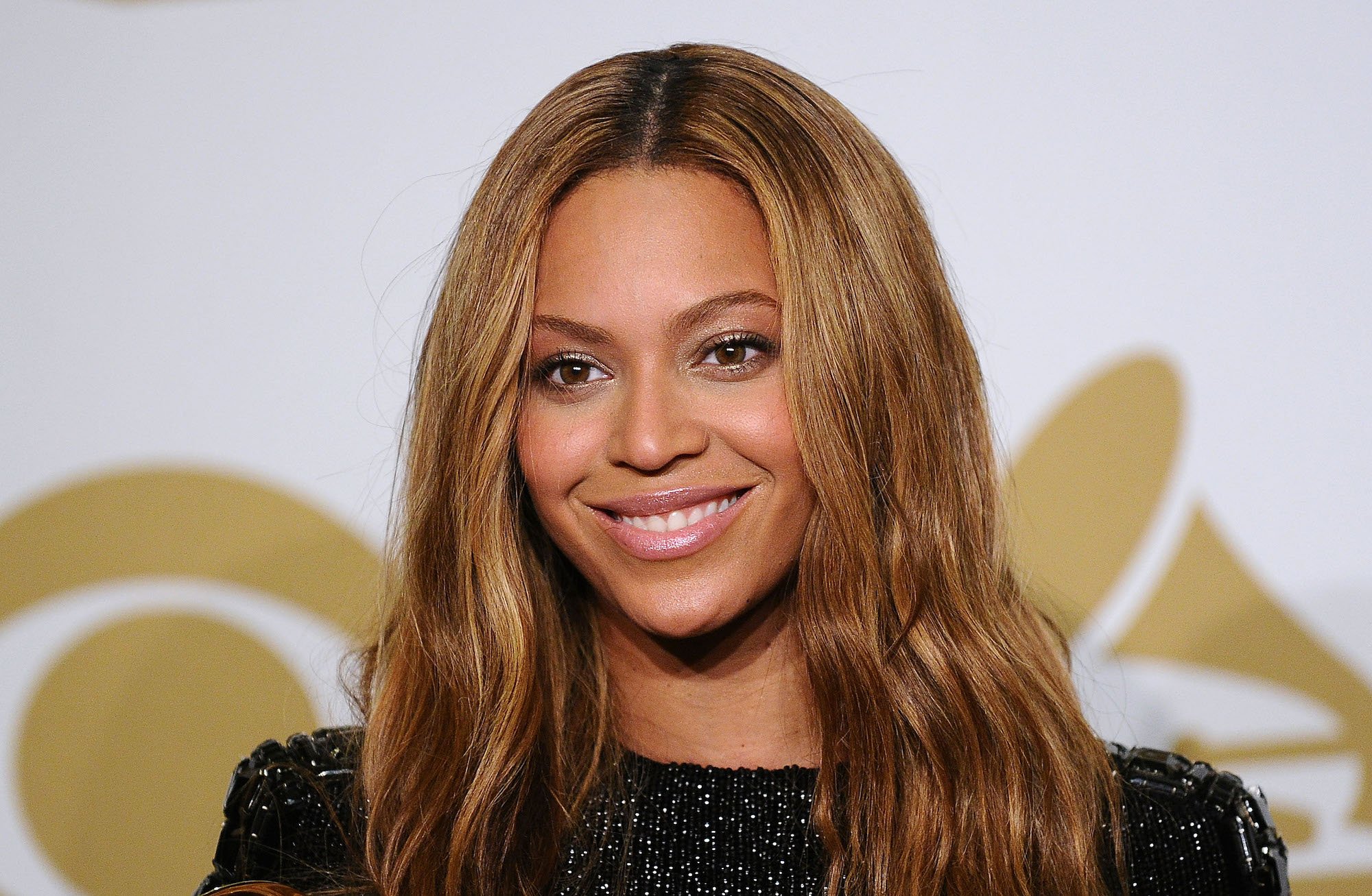 Beyoncé smiling looking below the camera