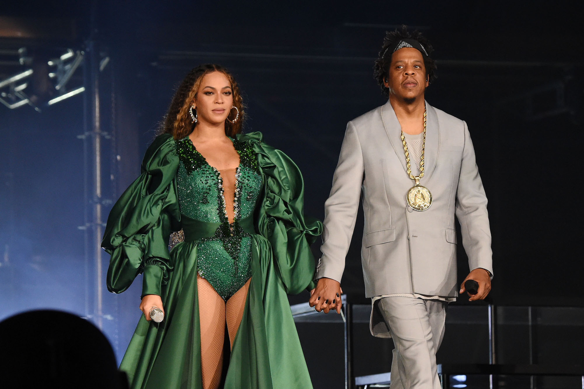 Beyoncé and Jay-Z smiling on stage, holding hands