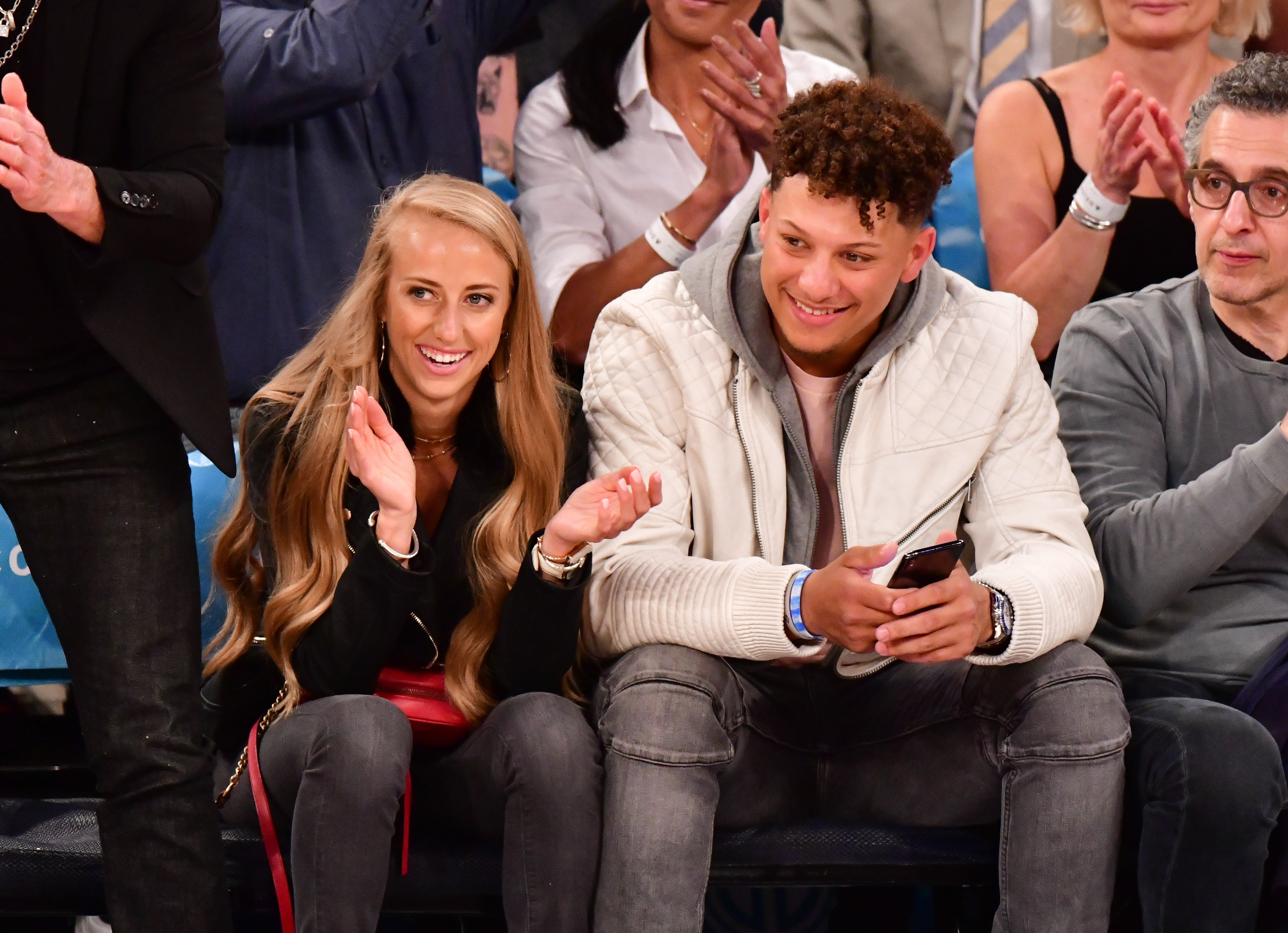 Patrick Mahomes and Brittany Mathews watching an NBA game