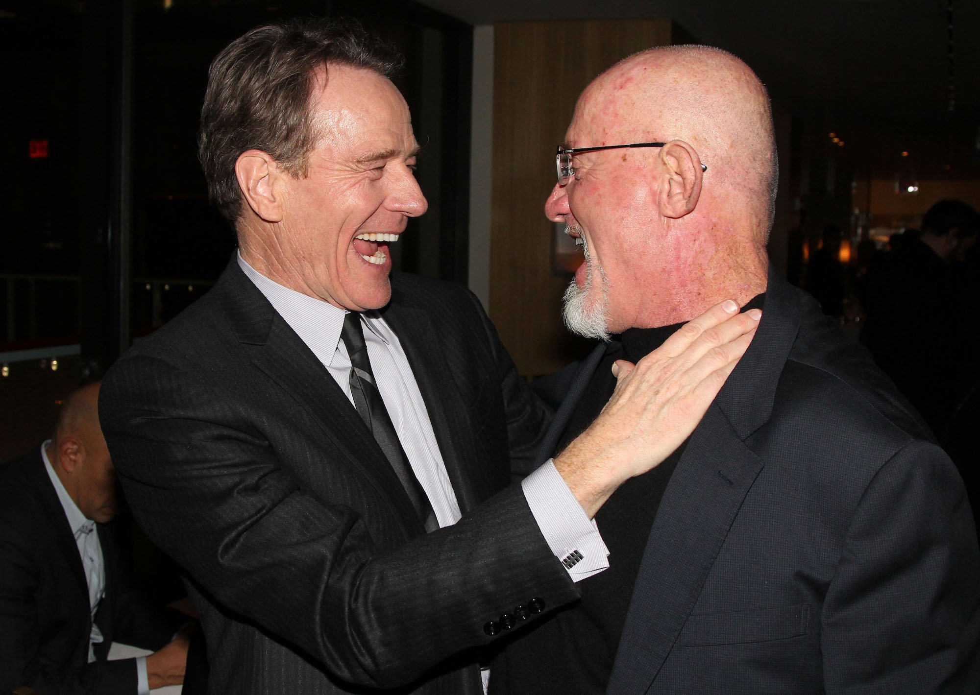 Bryan Cranston and Jonathan Banks turned to each other, smiling and laughing