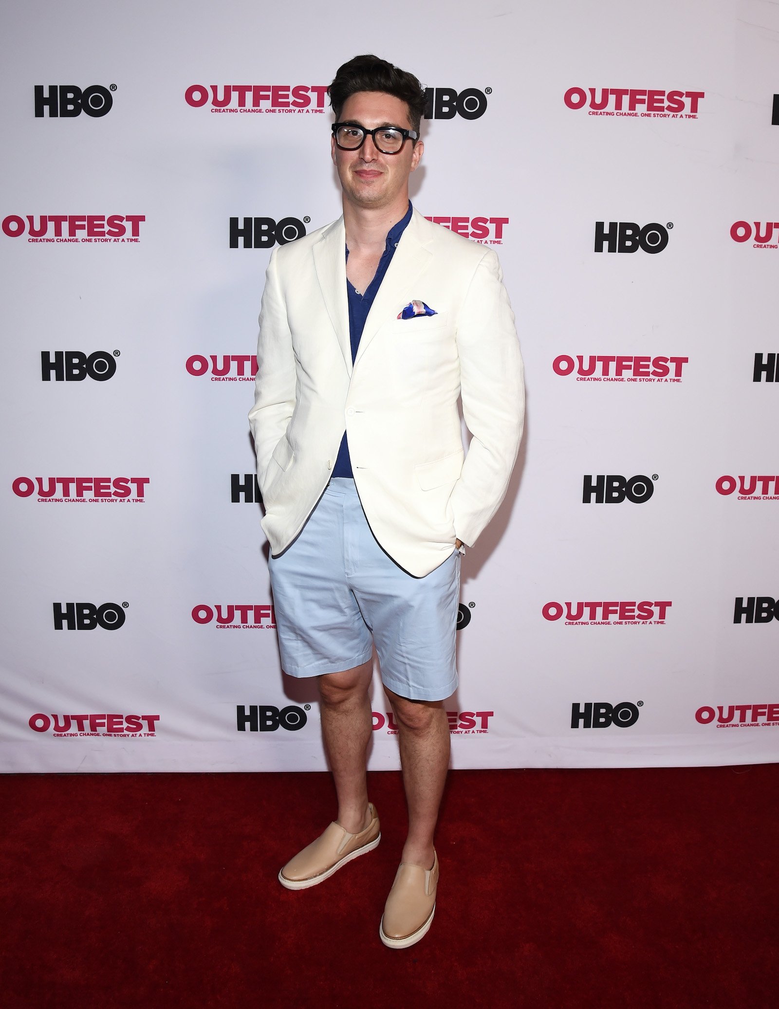 Buzzy Cohen poses on the red carpet at a screening of 'Gay Chorus Deep South'