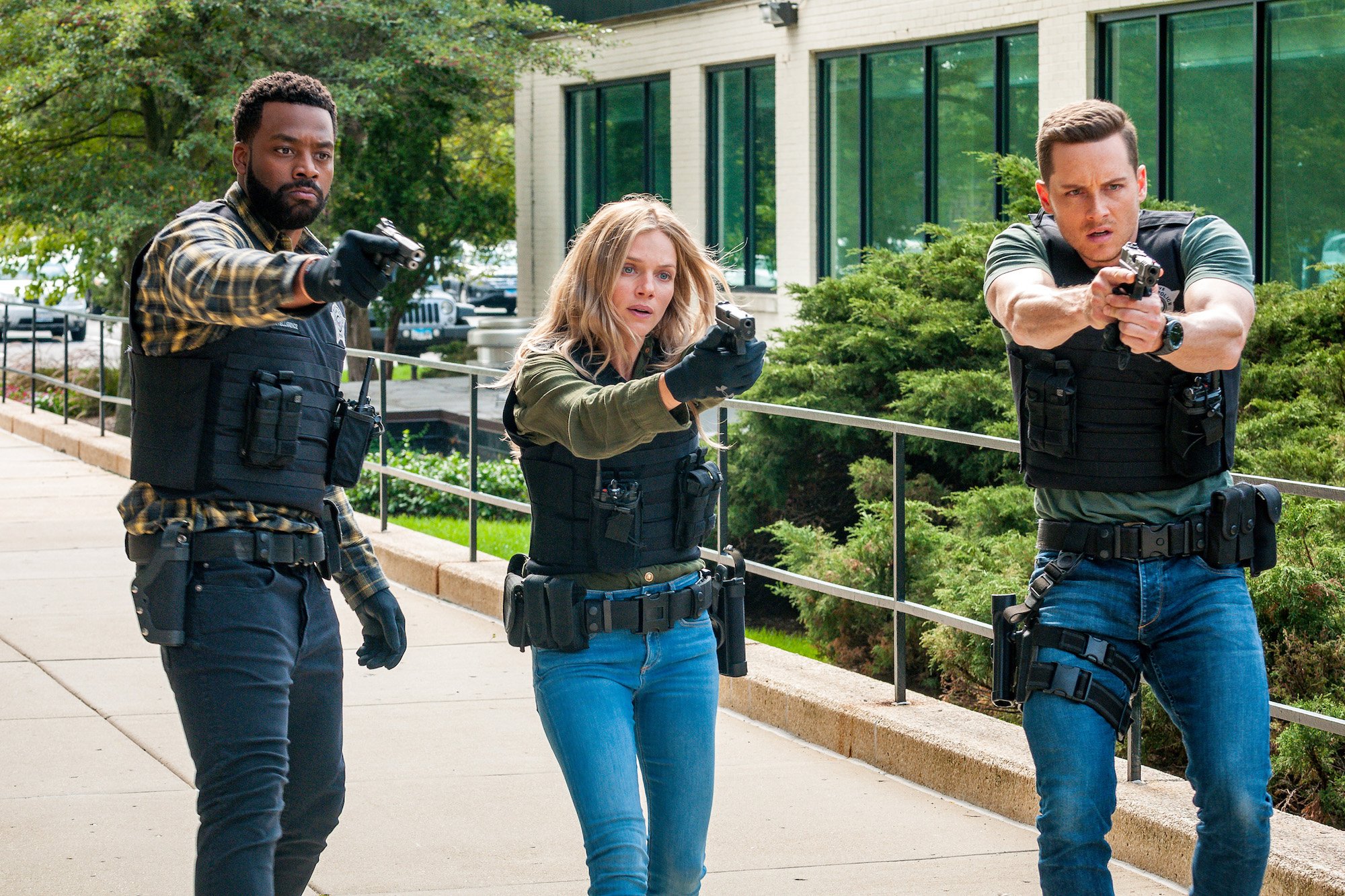 (L-R) LaRoyce Hawkins as Officer Kevin Atwater, Tracy Spiridakos as Det. Hailey Upton, Jesse Lee Soffer as Det. Jay Halstead with prop guns drawn