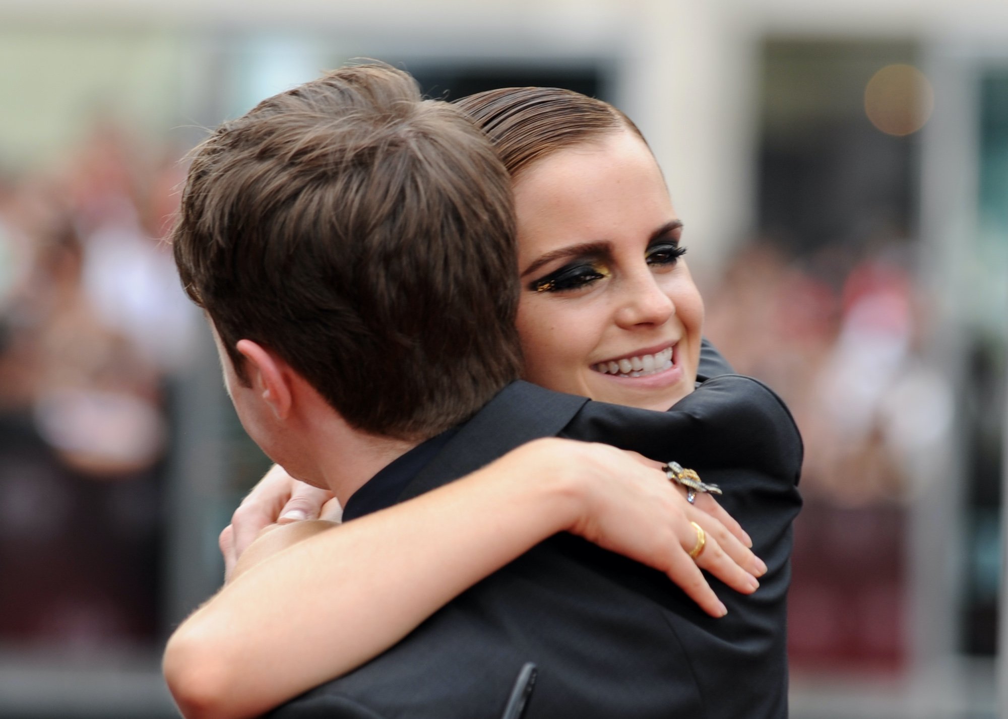 Emma Watson (R), gives a hug to Daniel Radcliffe (L), as they arrive for the North American premiere of Harry Potter and the Deathly Hallows Part 2