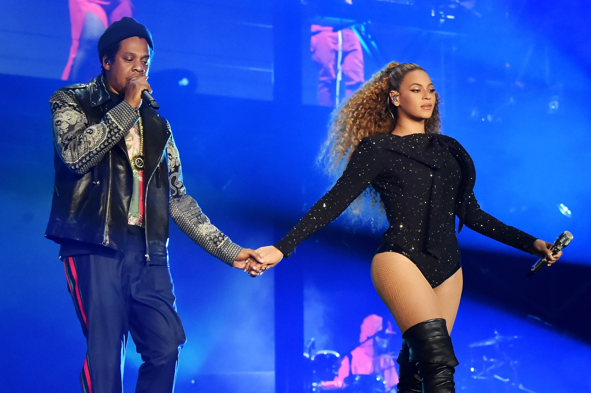 Jay-Z and Beyoncé holding hands on stage