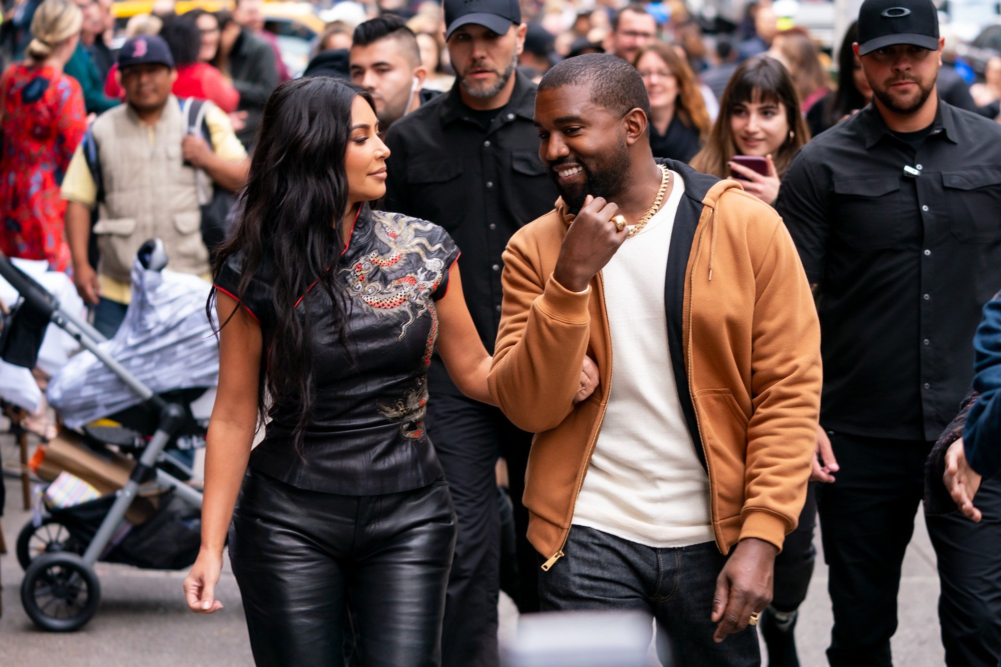 Kim Kardashian West turned, smiling at Kanye West, walking down the street
