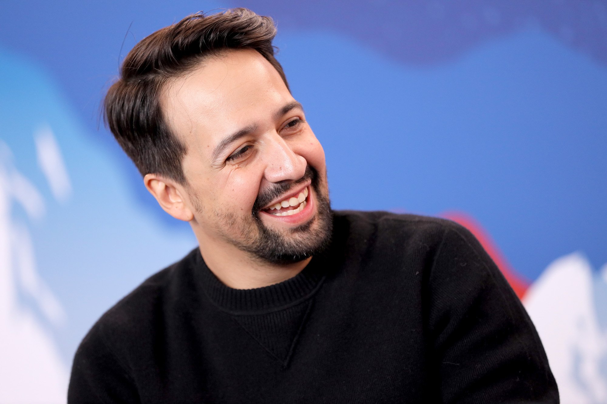 Lin-Manuel Miranda turned to the side, laughing