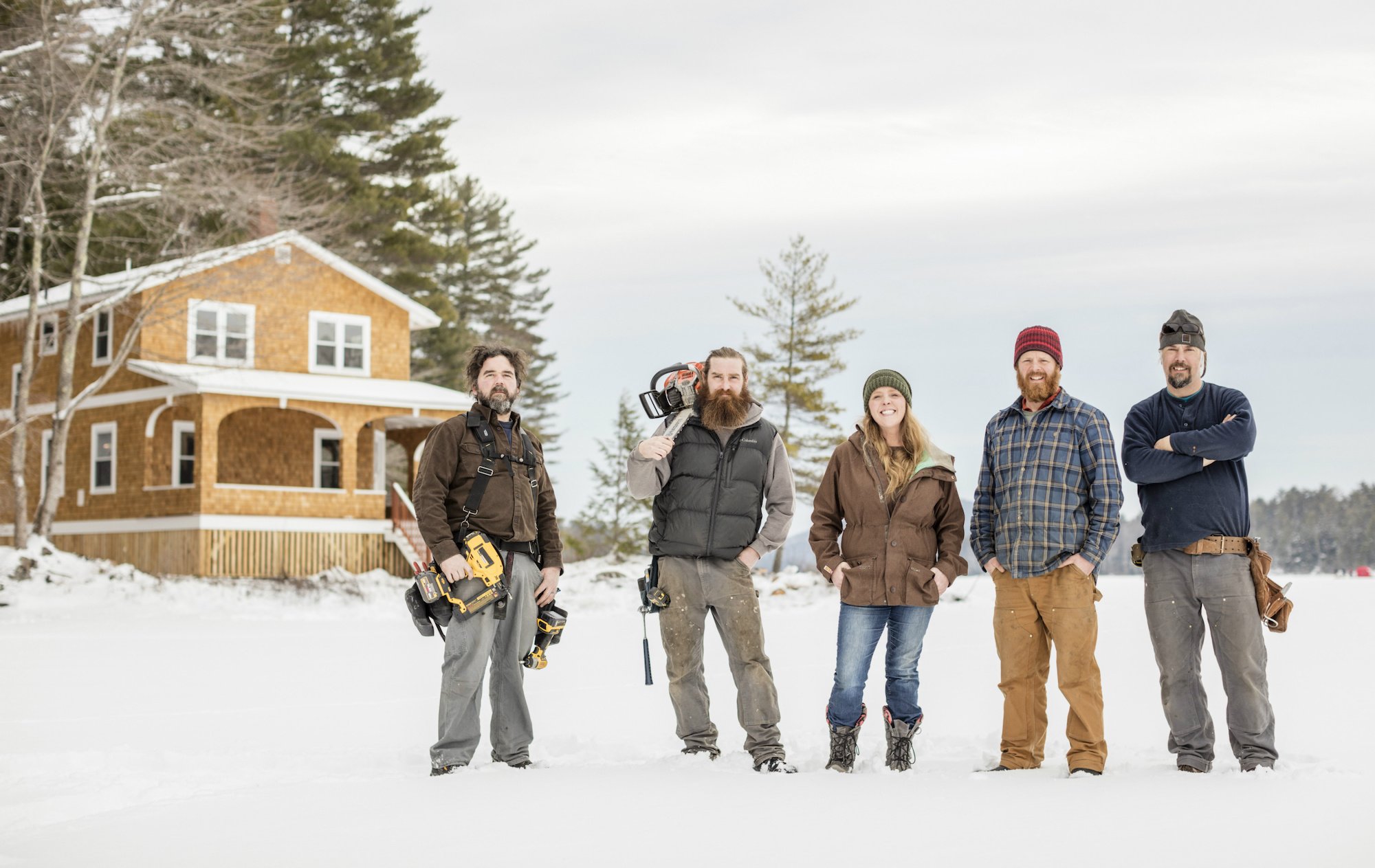 Cast of Maine Cabin Masters in a field covered in snow