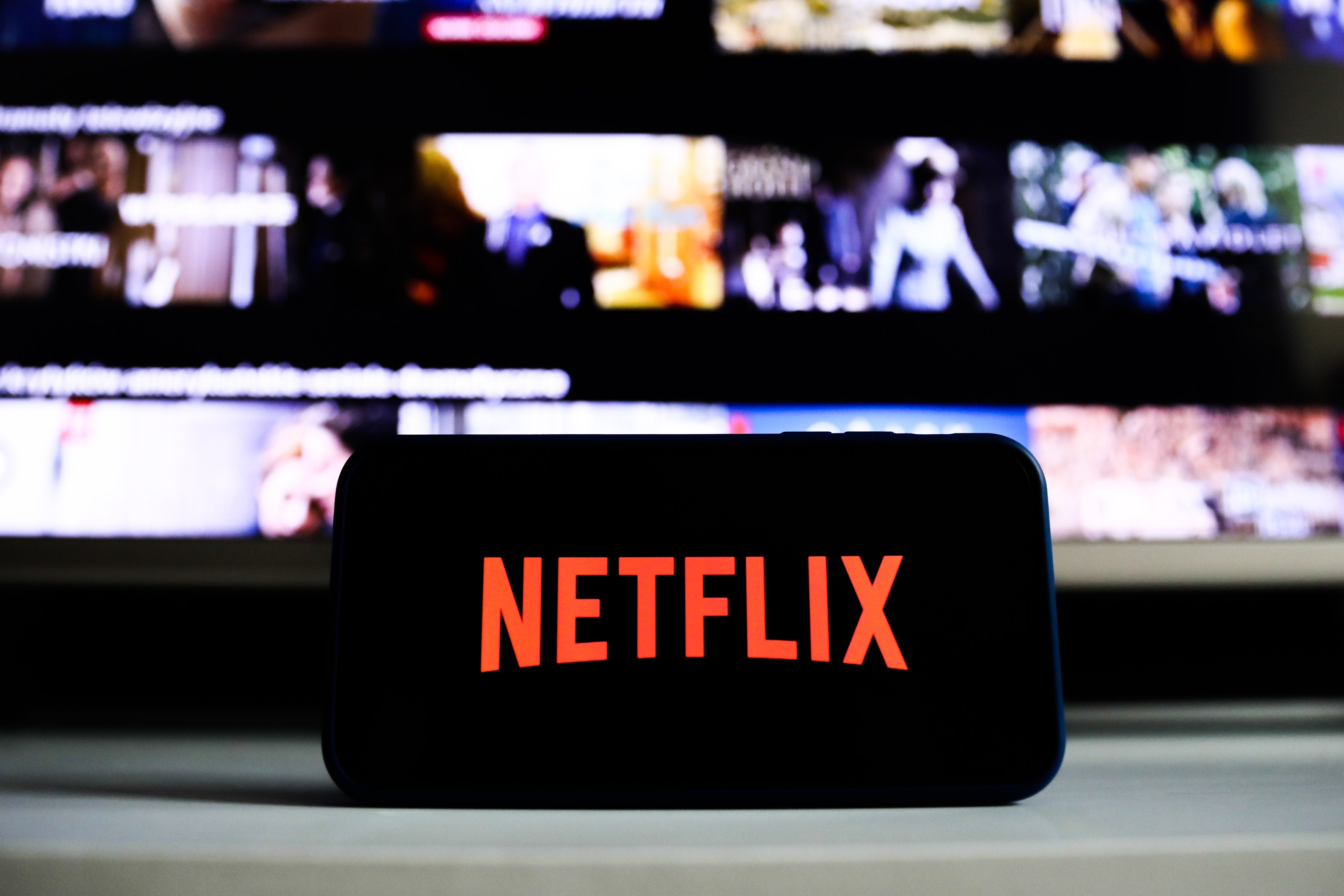 Netflix logo is seen displayed on phone screen