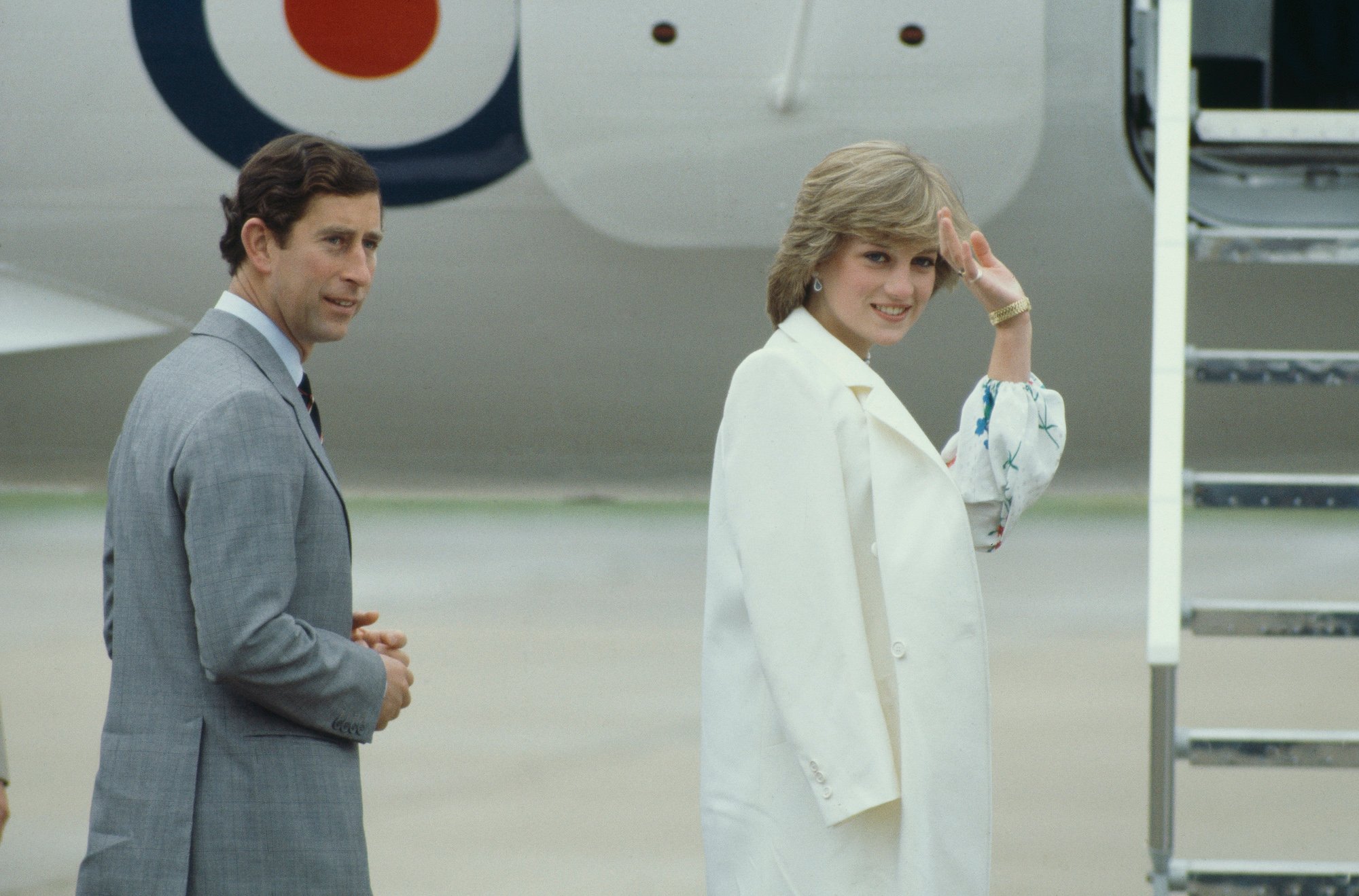 Princess Diana waves as she and Prince Charles get on a plane at the start of their honeymoon