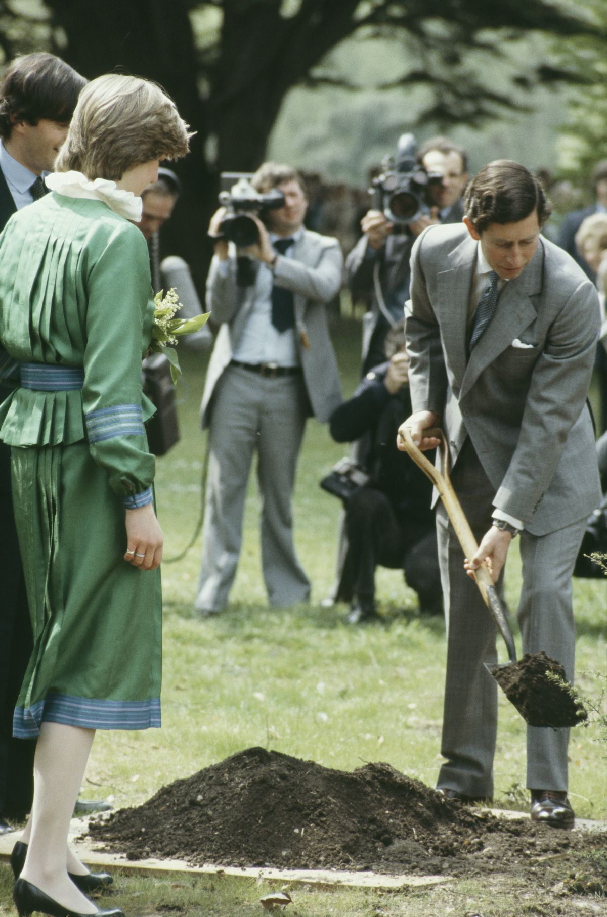 Princess Diana watches as Prince Charles' shovels dirt