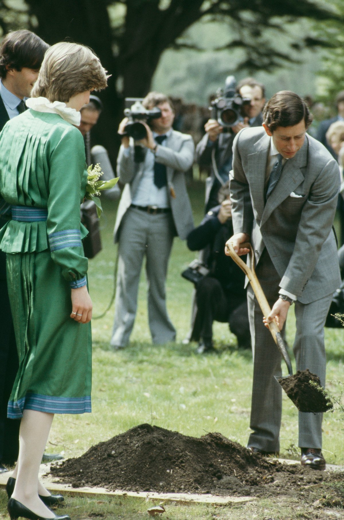 Princess Diana watches as Prince Charles' shovels dirt