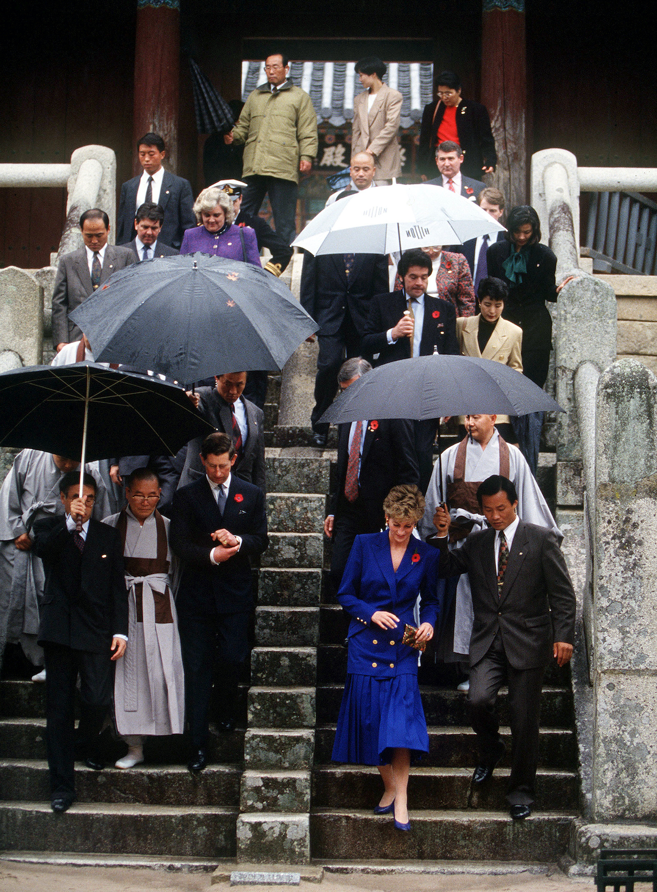 Prince Charles and Princess Diana walk down separate staircases at South Korean temple