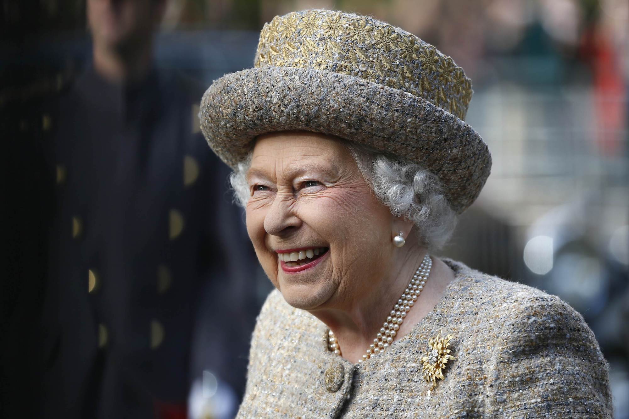 Queen Elizabeth II smiling looking away from the camera