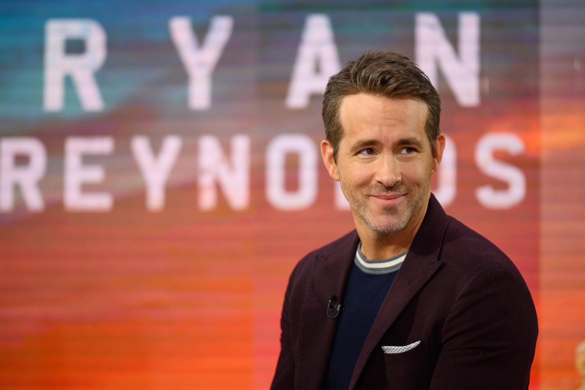 Ryan Reynolds smiling, looking off camera