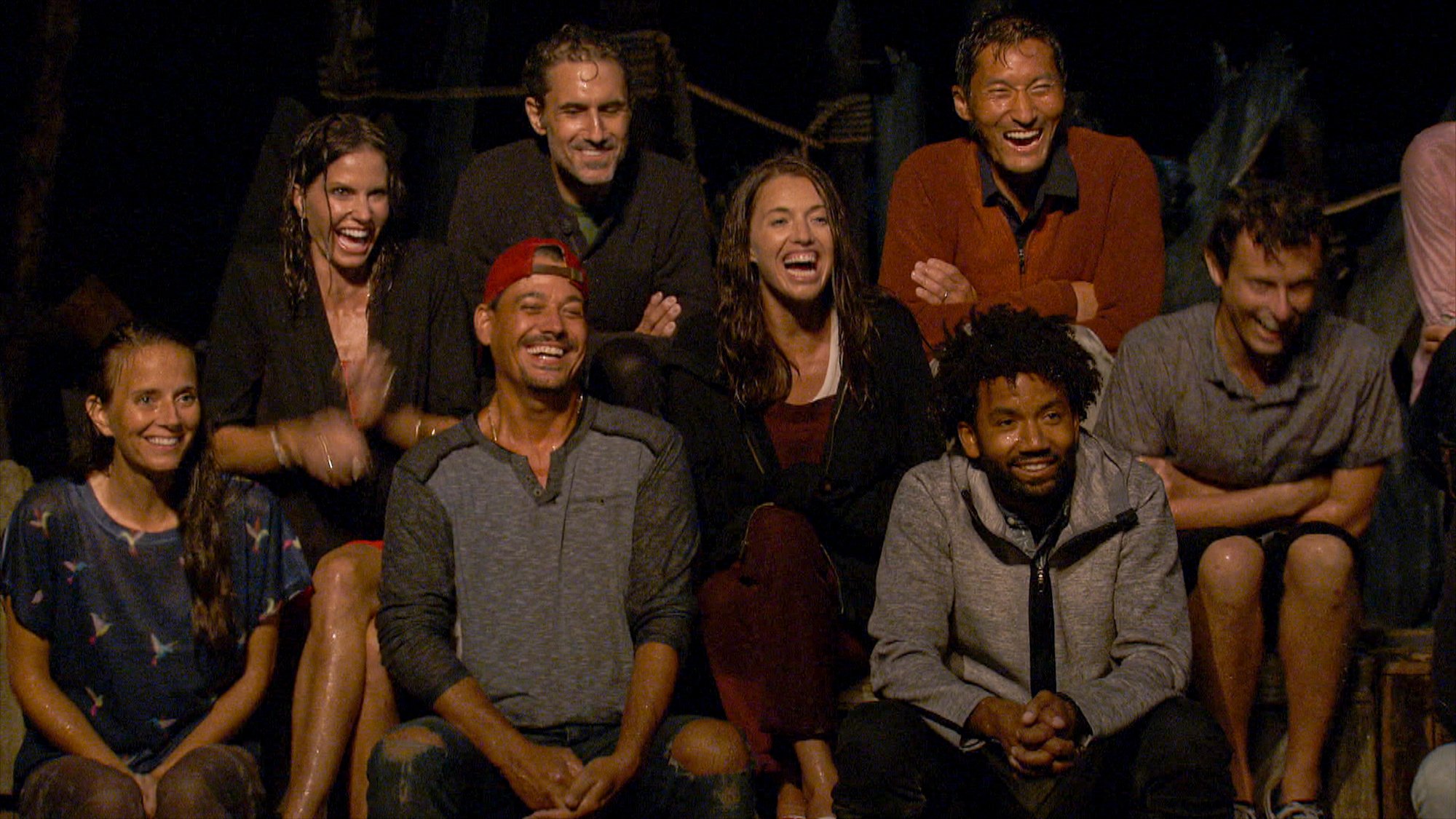 Amber Brkich Mariano, Danni Boatwright, Boston Rob Mariano, Ethan Zohn, Parvati Shallow, Yul Kwon, Wendell Holland and Adam Klein laughing at a tribal council