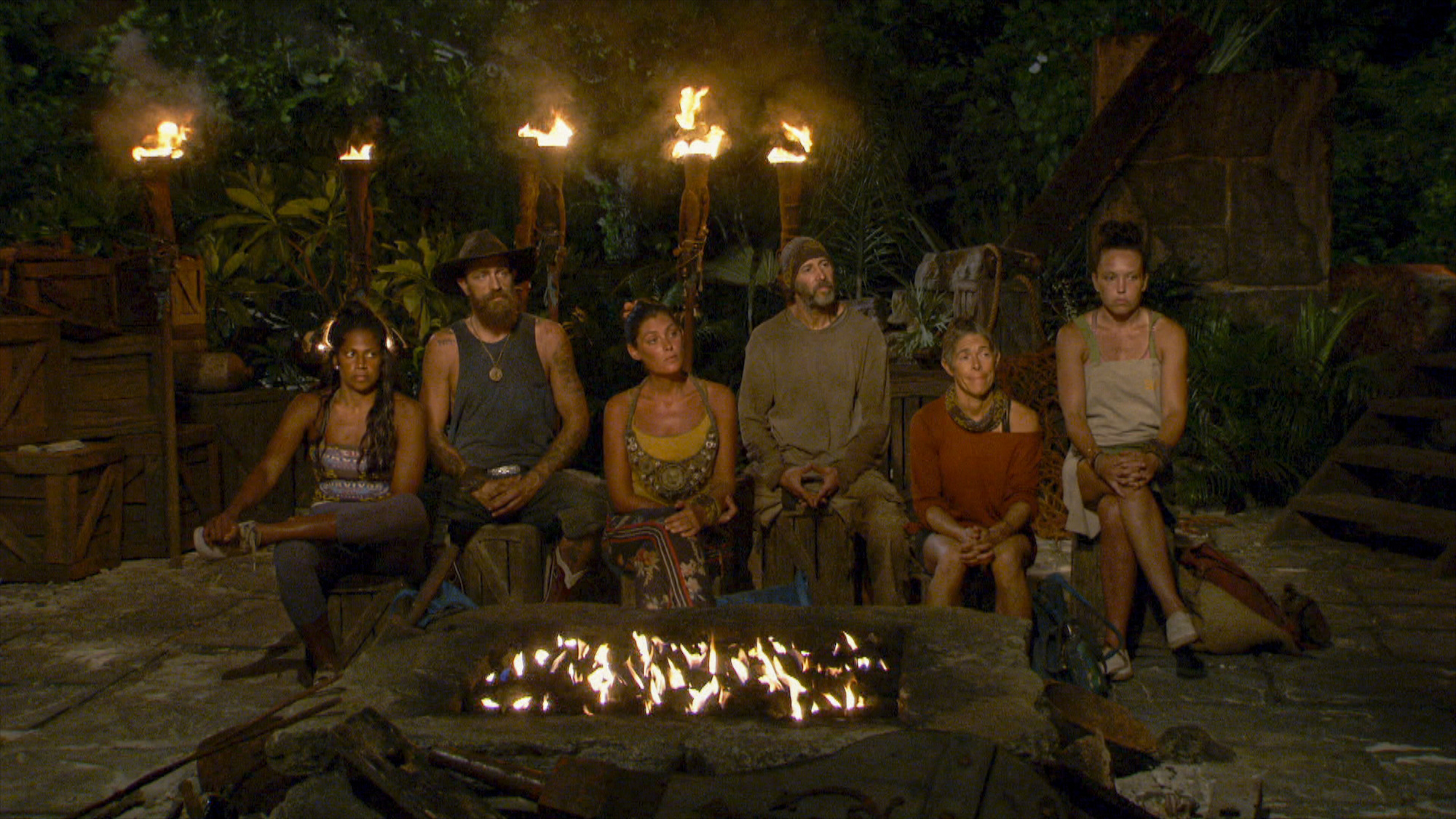 Natalie Anderson, Ben Driebergen, Michele Fitzgerald, Tony Vlachos, Denise Stapley and Sarah Lacina sitting around a fire at Tribal Council on 'Survivor'