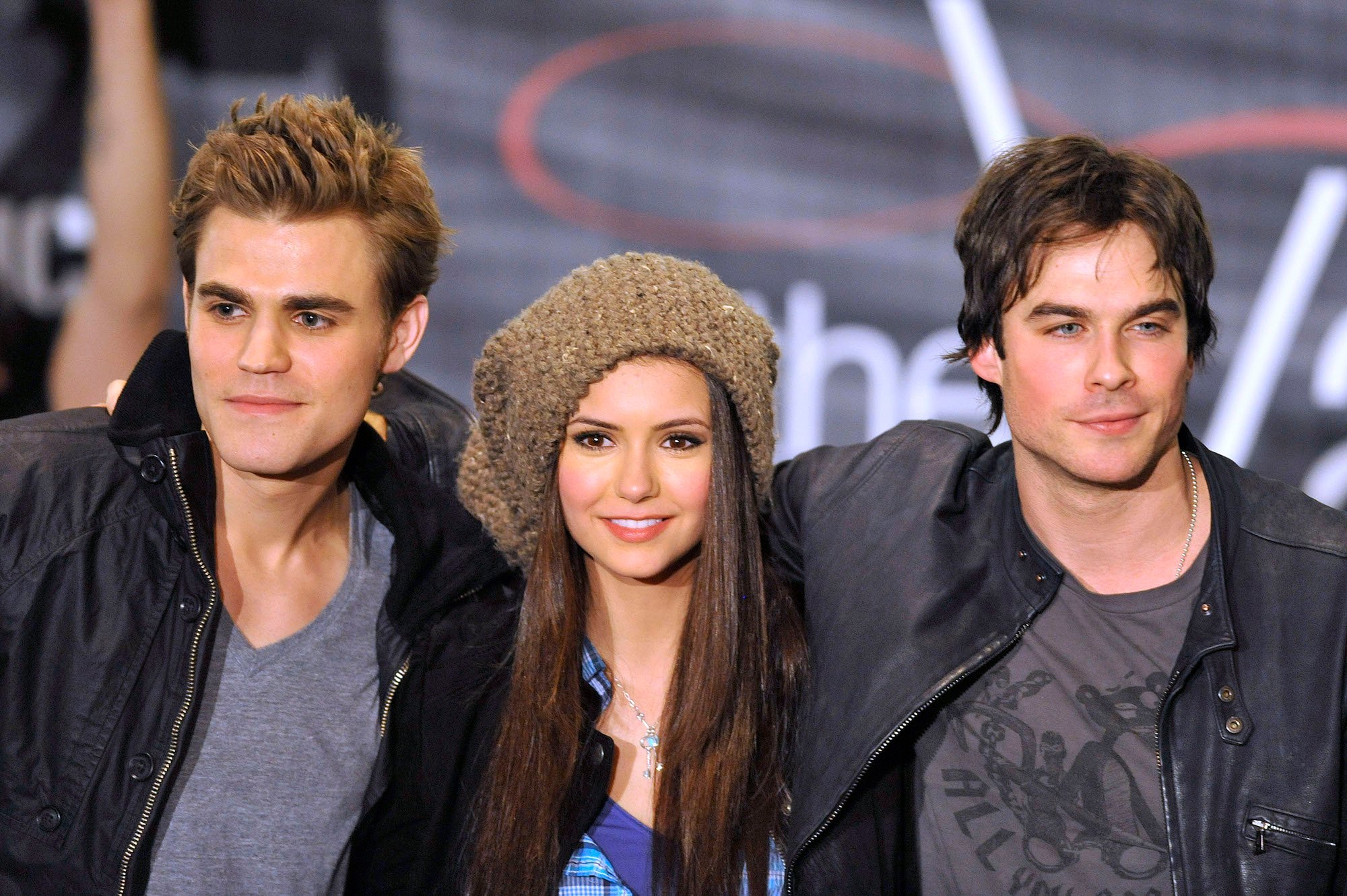 Paul Wesley, Nina Dubrev and Ian Somerhalder smiling