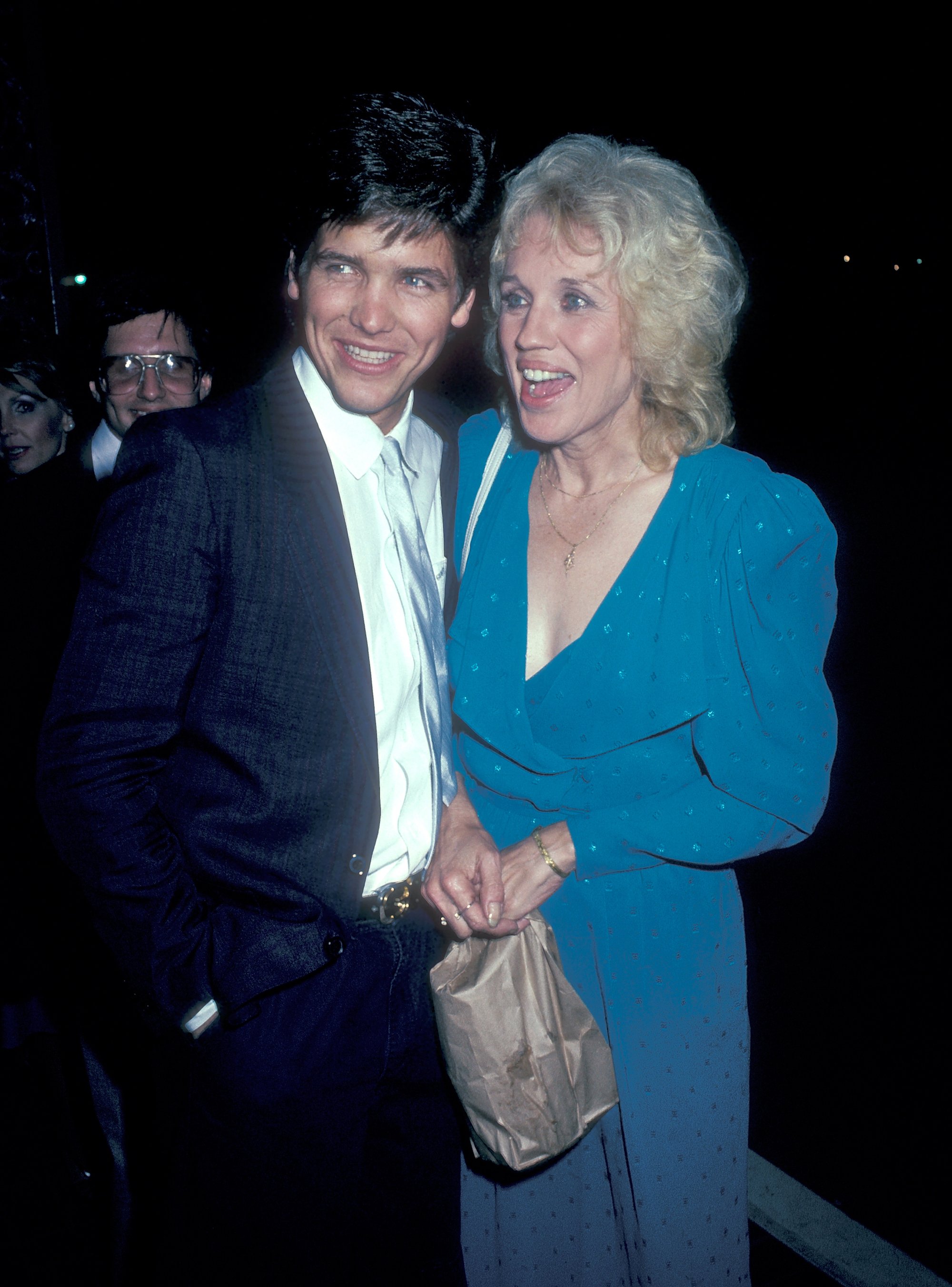 Michael Damian and Carolyn Conwell smiling looking away from the camera