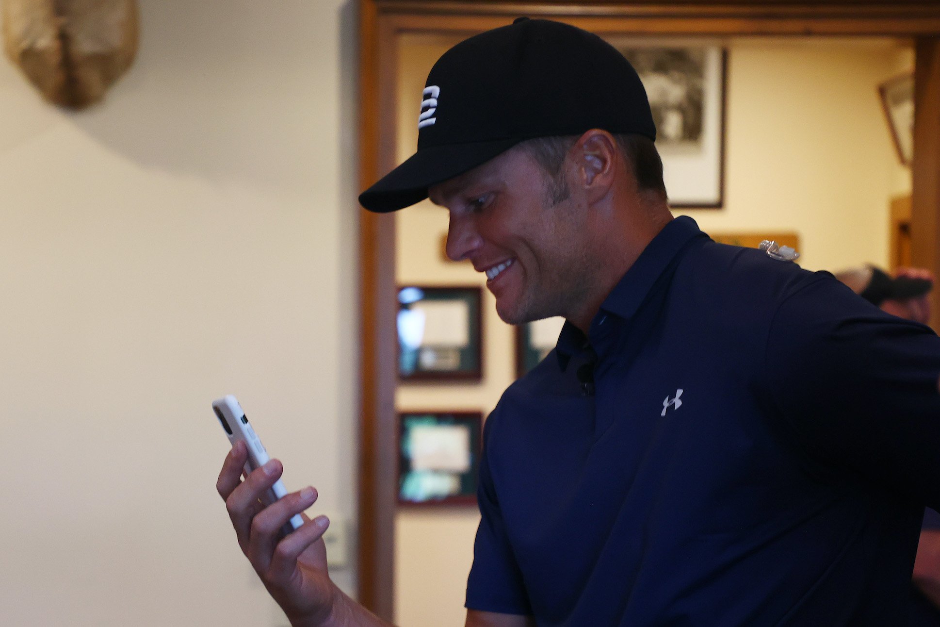 NFL player Tom Brady of the Tampa Bay Buccaneers waits out a weather delay in the clubhouse during The Match: Champions For Charity at Medalist Golf Club