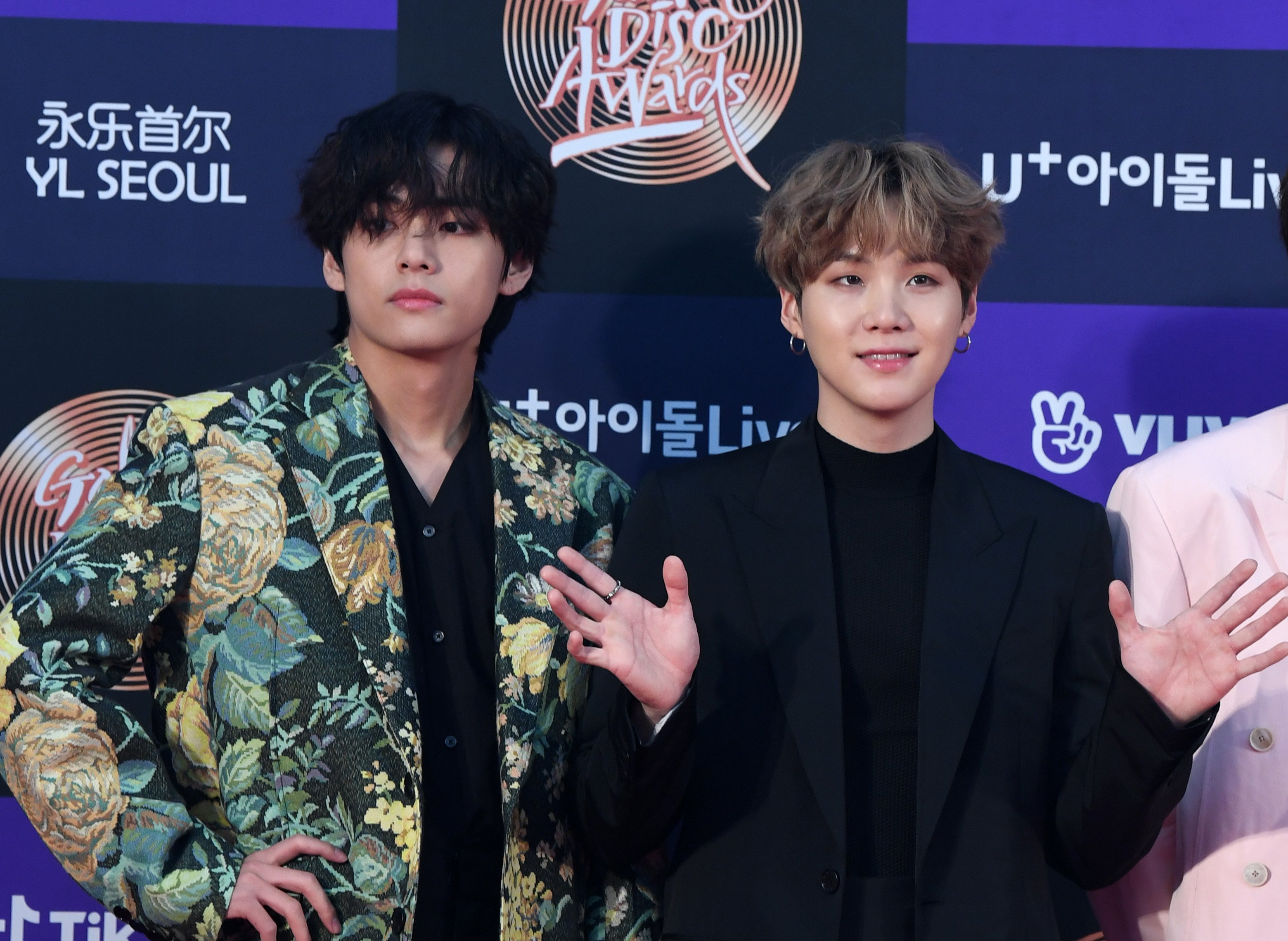 V and Suga of BTS arrive at the photo call for the 34th Golden Disc Awards